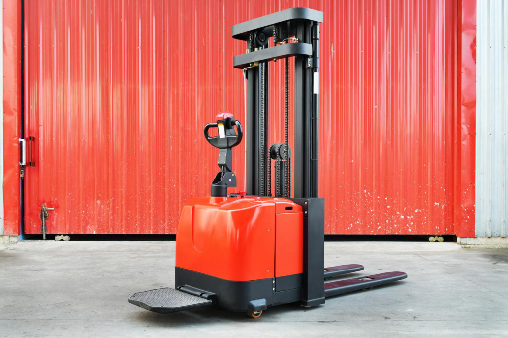 Red forklift pallet stacker, material handling equipment for warehouse.